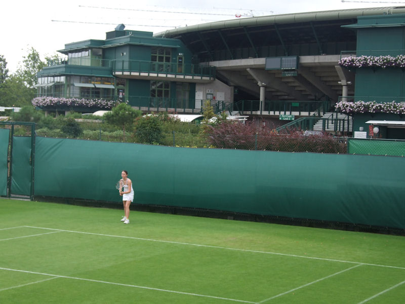 Dwarfed by the showcourt in the background, Amy Ellis is unfazed at the Road To Wimbledon.