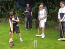 Playing croquet, undeterred by the rain